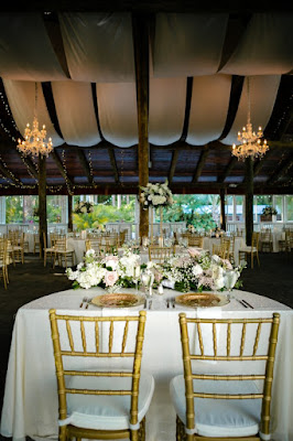 sweetheart table with white linen and gold chivari chairs