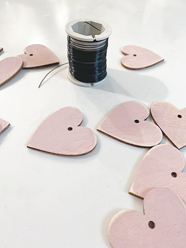 sanded pink hearts and a spool of wire