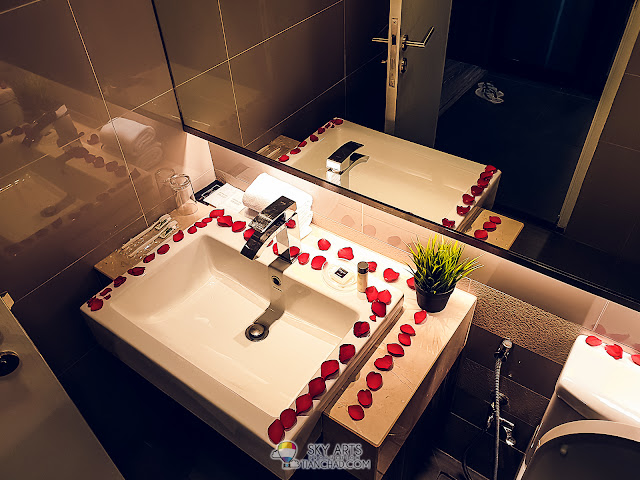 Simple decoration of the toilet with fresh rose flower petals at Ramada KLCC