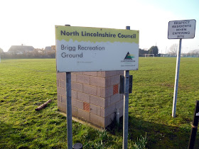 Brigg Recreation Ground's entry sign and one of the football pitches - February 2019