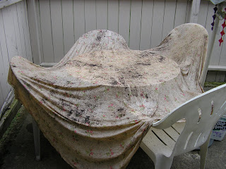 Fabric draped over plastic patio furniture to dry.