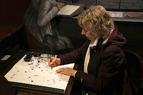 Rachel trying to write with a pen and ink at the Jane Austen Centre in Bath