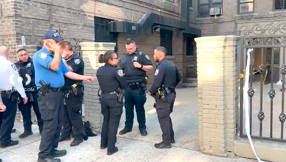 Officers stand guard at the scene where a 17-year-old girl was stabbed to death in the Bronx. -Citizen