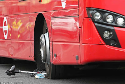 Cyclist freed from underneath a bus by crowd