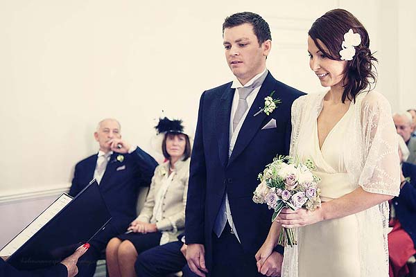 bride and groom holding hands during ceremony at Marylebone Town Hall wedding