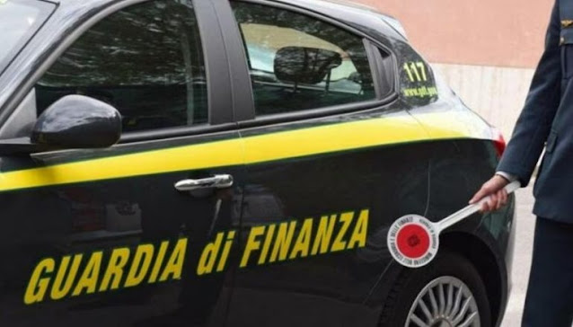 Guardia di Finanza vehicle and an Officerf in the right with a stop sign stick on his right hand