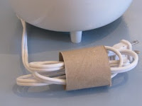 Appliance cord is folded up and stuffed in the empty paper roll. Neat and easy!