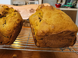 Two pumpkin loaves on cooling rack.