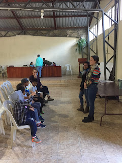 Kaitlin and Jossel giving an English lesson to a small group of children in Principal