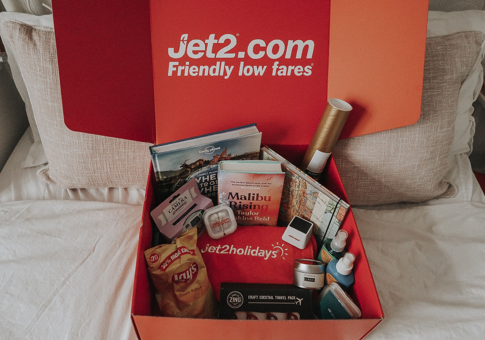 A red Jet2.com box with travel essentials.