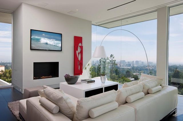 Living room with glass walls and modern fireplace 