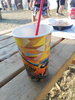 a paper cup of iced lemonade, decorated with a parrot