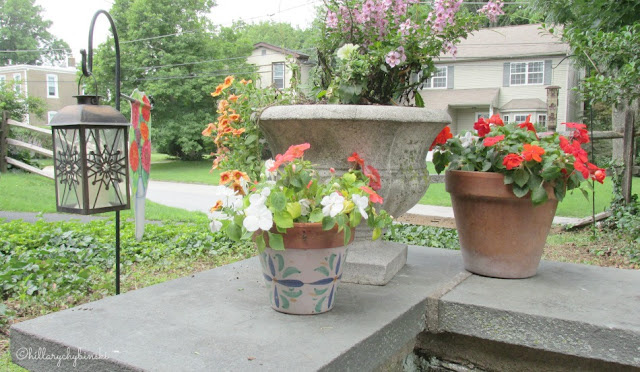 Add some easy plants and flowers in small, inexpensive pots for pops of color and to soften sapces