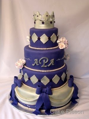 Purple fondant with silver accents covers the cake with more fondant drapes