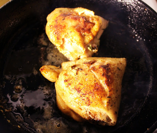 Chicken Thighs with Romesco Sauce, Shaved Manchego, and Charred Onions