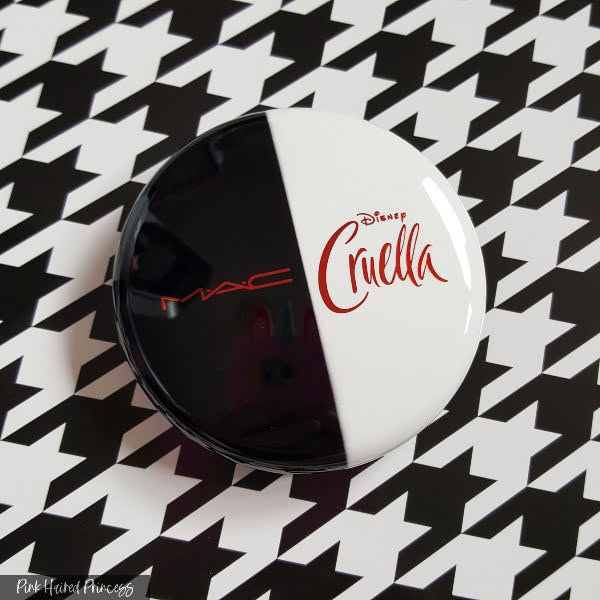 black and white high shine compact with Cruella MAC Disney branding in red metallic