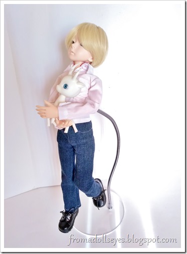 A bjd holding a small deer pretending to fly using the invisible doll stand.