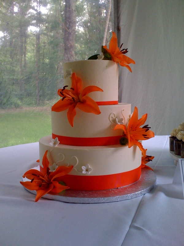Wedding Cake Buttercream Tiers with Real Lillies and White Scrolls 