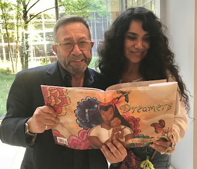 Editor and publisher Neal Porter with author illustrator Yuyi Morales, holding a copy of DREAMERS