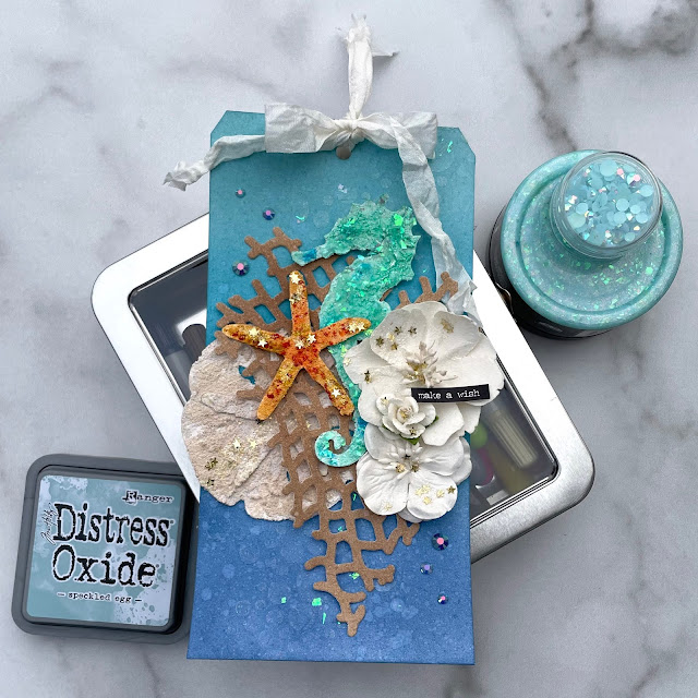 Ocean themed mixed media tag created with Tim Holtz distress oxide inks and dies