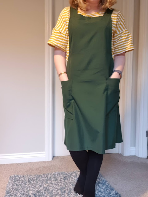 Green pinafore dress with yellow striped top