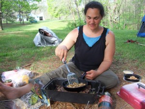 woman cooking morels outside