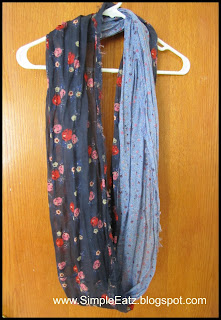 Two colored scarf. Half is light blue. Other half is dark blue with red pink flowers