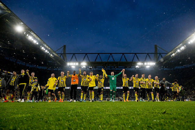 The Borussia Dortmund team, ready to etch their names in history as they stand on the cusp of a monumental Bundesliga title victory. One game stands between them and glory.
