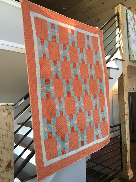 Contemporary Nine Patch quilt pattern made in orange and blues