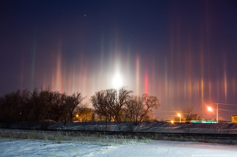 Arctic air combines with river steam and a corn milling plant's steam to produce light pillars over Blair Nebraska, thanks to ice crystals floating in the air from the steam sources. A setting moon adds to the scene, creating a light pillar of its own. Arctic air combines with river steam and a corn milling plant's steam to produce light pillars over Blair Nebraska, thanks to ice crystals floating in the air from the steam sources. A setting moon adds to the scene, creating a light pillar of its own.