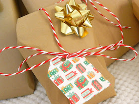 A close up photo of a christmas present wrapped using brown paper and string