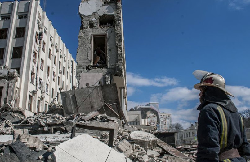 In Kharkiv, Ukraine, rescuers work at the site of the National Academy of State Administration building, which was destroyed by shelling.