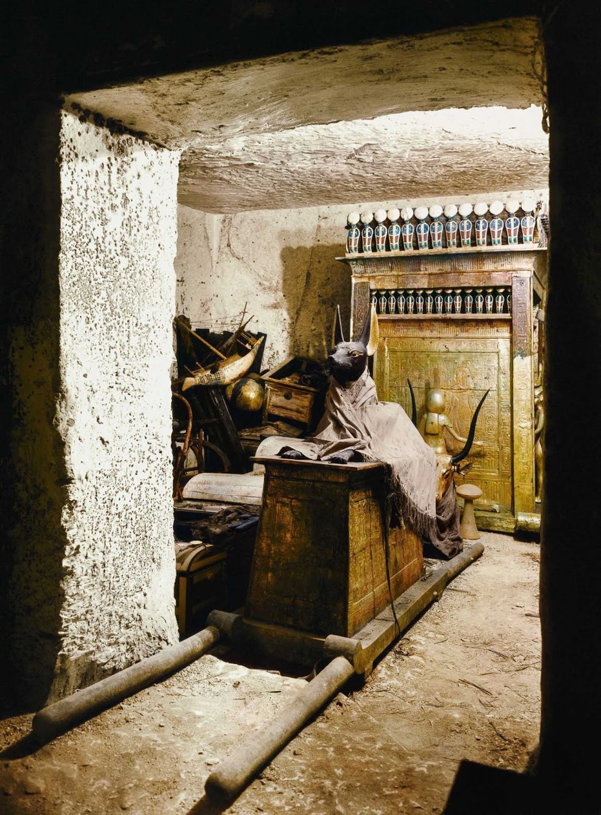 A statue of Anubis on a shrine with pallbearers' poles in the treasury of the tomb.