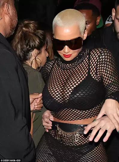 Amber Rose leaves little to the imagination in fishnet outfit