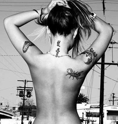 female back tattoos. upper ack tattoo tribal and