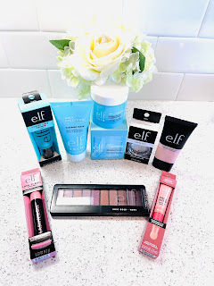 Eight E.L.F Cosmetics products arranged on a counter with white flowers.