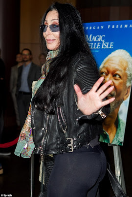 Cher playfully waves at the camera