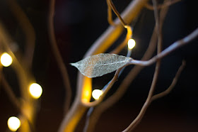Decorative fairy lights and skeleton leaf tree
