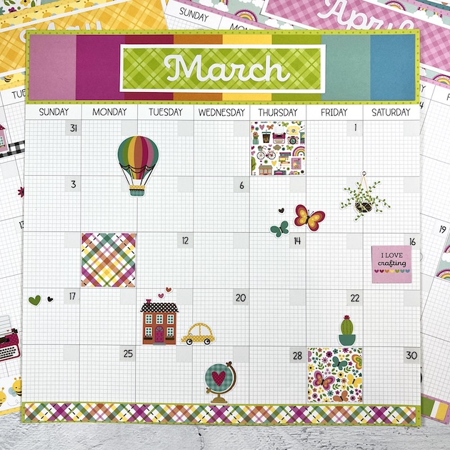 12x12 Monthly Calendar Scrapbook Layout with a hot air balloon, butterflies, and lots of other cute stickers