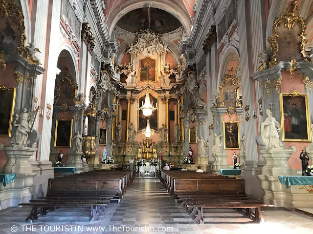 Pastel ornate interior and view towards the altar at Saint Theresa church in Vilnius in Lithuania