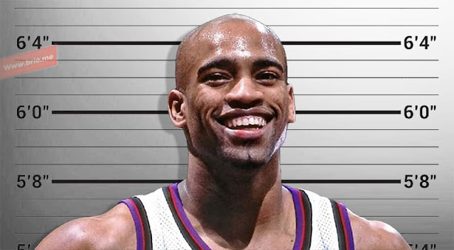 Vince Carter posing in front of a height chart background