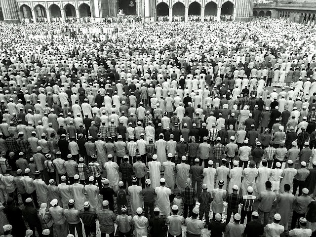 Aaditya visited Jama Majid and brought us some beautiful shots of the Eid Celebrations and prayers being offered. altWhile offering the prayers, people stand in queues, shoulder to shoulder, rich, poor, old, and young alike. This has been beautifully captured in thispicture.The pigeons fly above Jama Masjid as people offer prayers below. The picture speaks of peace and serenity.All devotees are equal before Allah, and on this auspicious day, all are in His presence - Blessed!Dear Allah, I leave my human ego behind and bow before you. You and only you are The Supreme Being. Devotees throng the premises of Jama Masjid. Those who can't get in, sit outside. There is no place in this world which is devoid of the presence of thLord, be it inside or outside the mosque. Any alms given in your name, My Lord, shall only go to those who need help. It is my promised that it will be used for good cause.