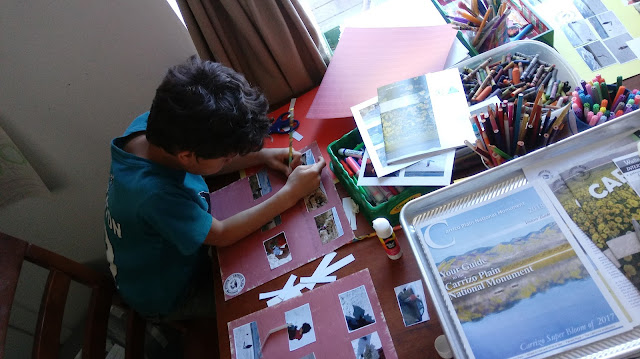 my oldest working on his scrapbook