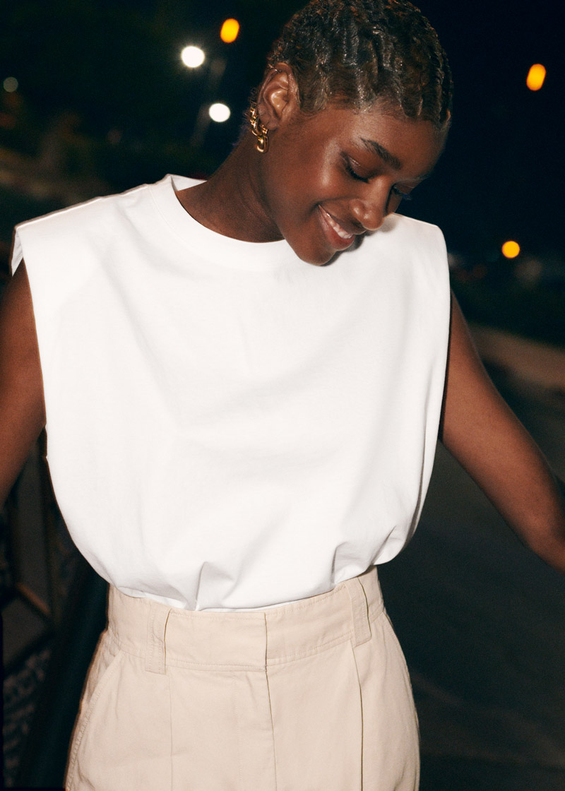 minimalist summer going out look inspiration white padded-shoulder top and high waisted tan pants