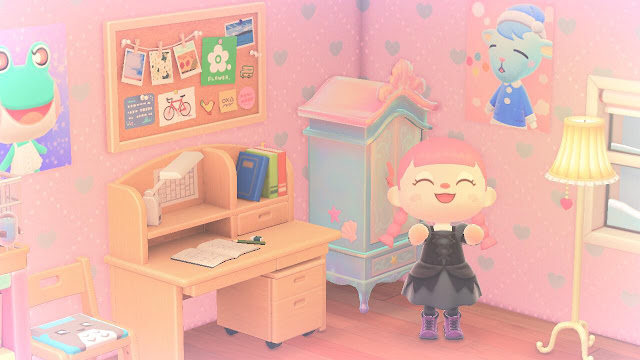 A photo of a bedroom on the game Animal Crossing New Horizons. It is filled with kawaii furniture. There is a pink haired character clapping and smiling