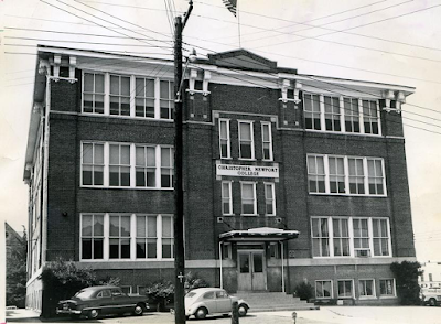 a black-and-white photograph of a boxy three-story brick building. Above the doorway reads, "Christopher Newport College."