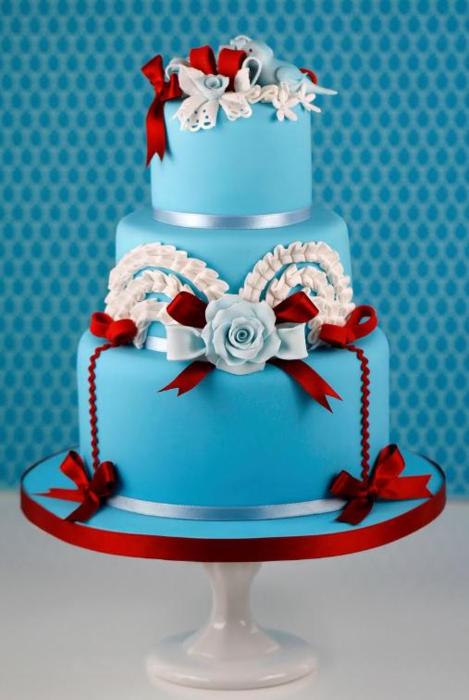 Square turquoise and white cake with red flower accents