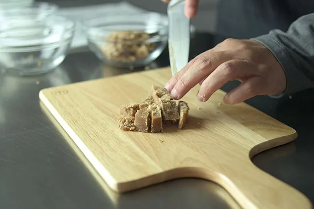 Cut palm sugar into chunks.