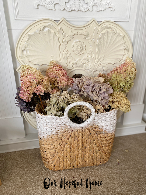 painted seagrass basket filled with dried hydrangeas