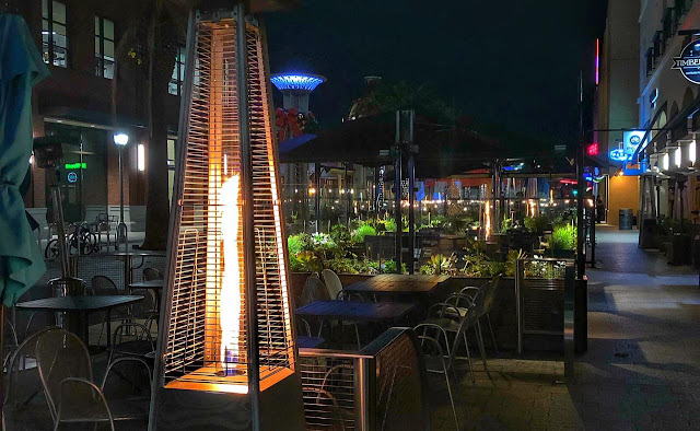 While walking around Redwood City Downtown, I noticed restaurants getting ready for one of the evenings. And when I was heading back, all these places were full of people on the dinner tables. Above photograph shows one of the fire-pits which are installed around the dining area. December is pretty chilly in San Francisco Bay Area. These fire-towers help keeping the place warm and comfortable to enjoy the meal. Christmas Lights were also all around these restaurants. Even the small plants between the dining tables were well lit with colourful lights of Christmas.